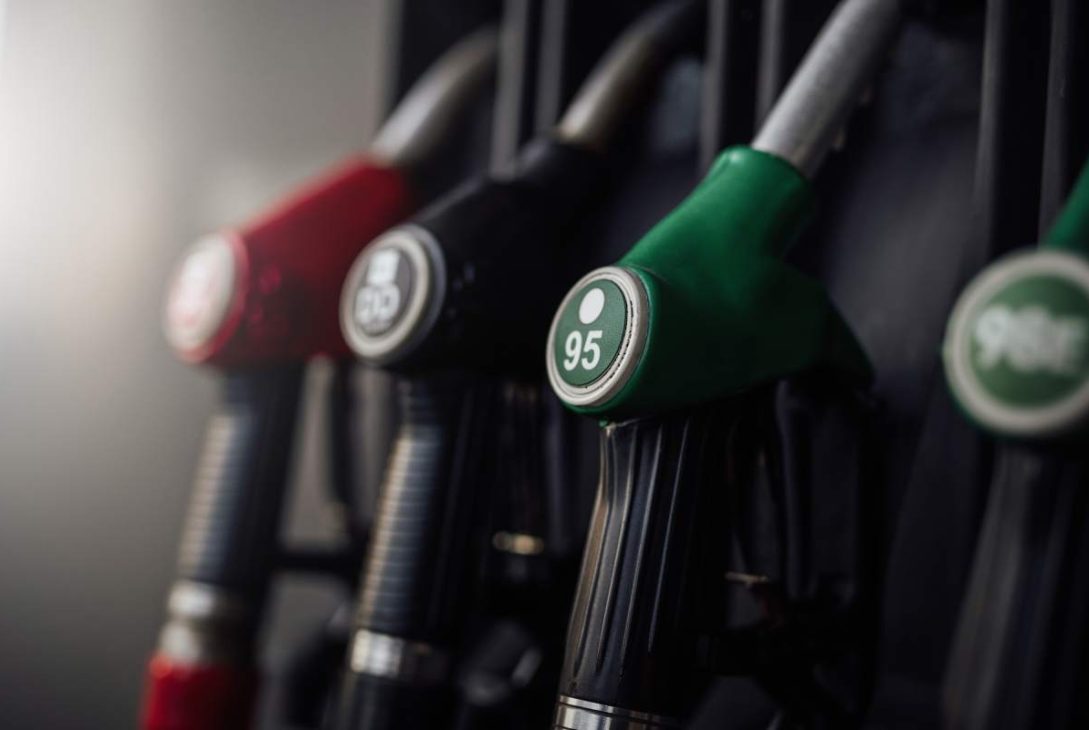 A bright photography of guns with various colours. Modern refueling station. No people.