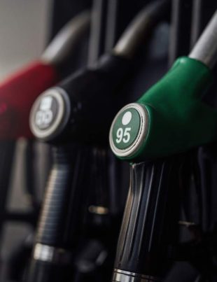 A bright photography of guns with various colours. Modern refueling station. No people.