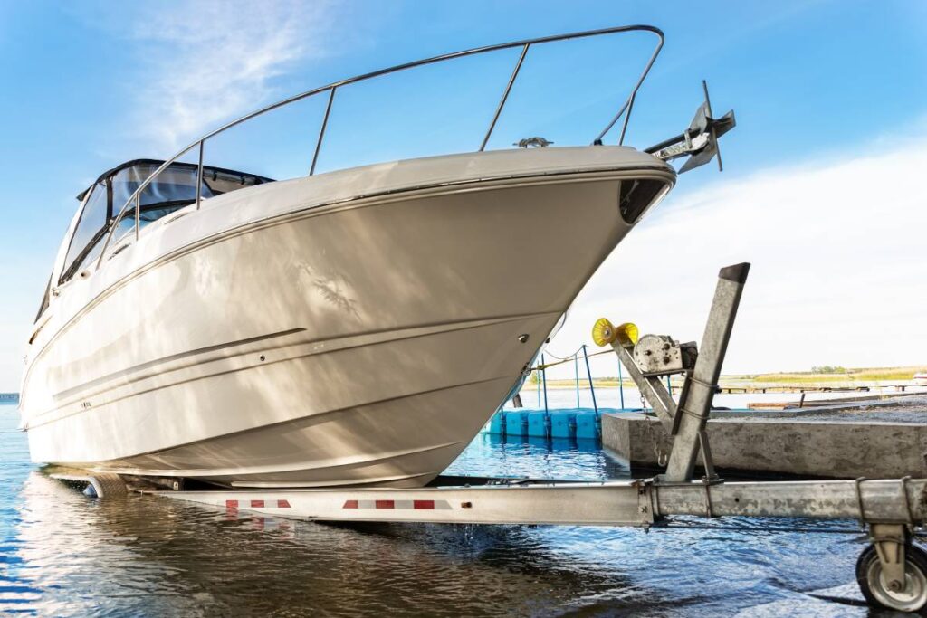 boat, trailer, truck, launch, ramp, lake, vehicle, hauling, river, travel, water, marina, marine, sky, blue, sunrise, sunset, small, yacht, motorboat, speed, motor, powerboat, jet, power, engine, fishing, luxury, rich, big, private, recreation, equipment, towing, summer, usa, uk, cruiser, lifestyle, floating, speedboat, sun, ship, beach, coast, bay, shore, calm, reflection, wealth